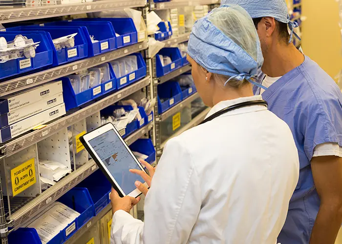clinician checking analytics in supply room
