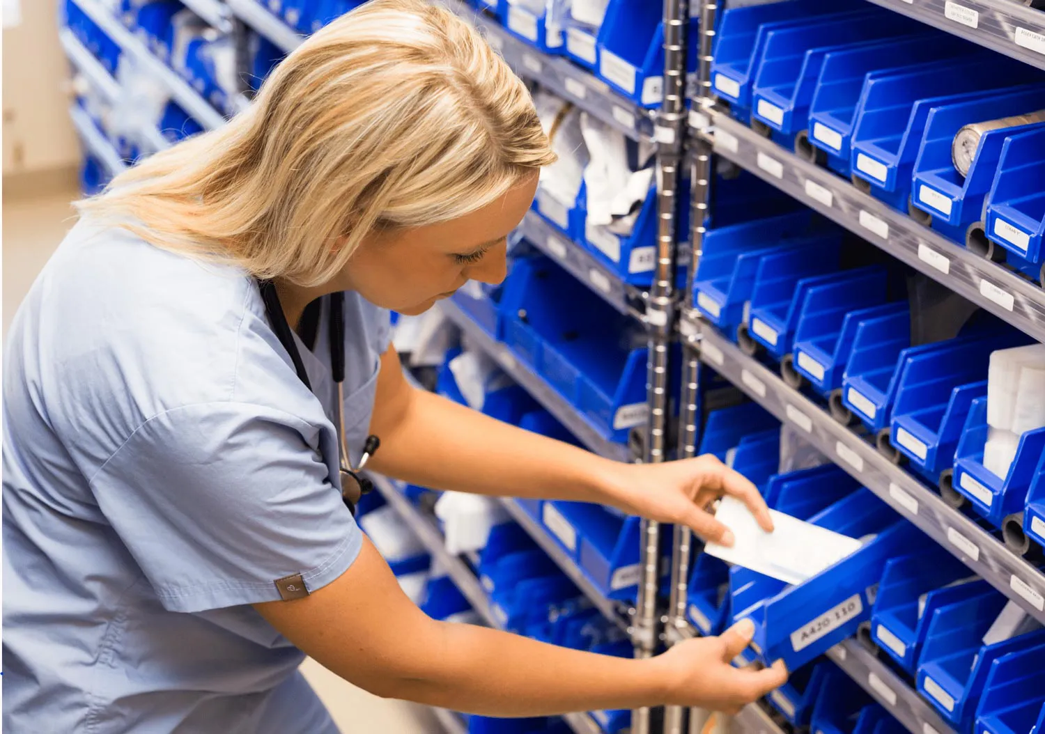 nurse grabbing supplies from kanban bin